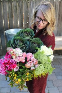 Amanda, founder of Bloom, holding DIY flower bouquet