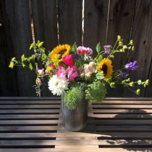 Bloom bouquet on wooden table.