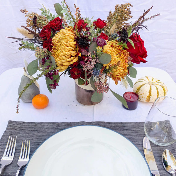 Flowers next to a place setting.