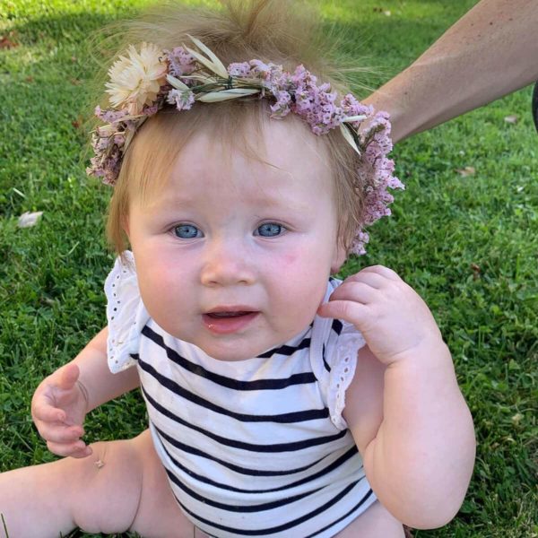 Baby wearing flower crown made by Bloom Sacramento.