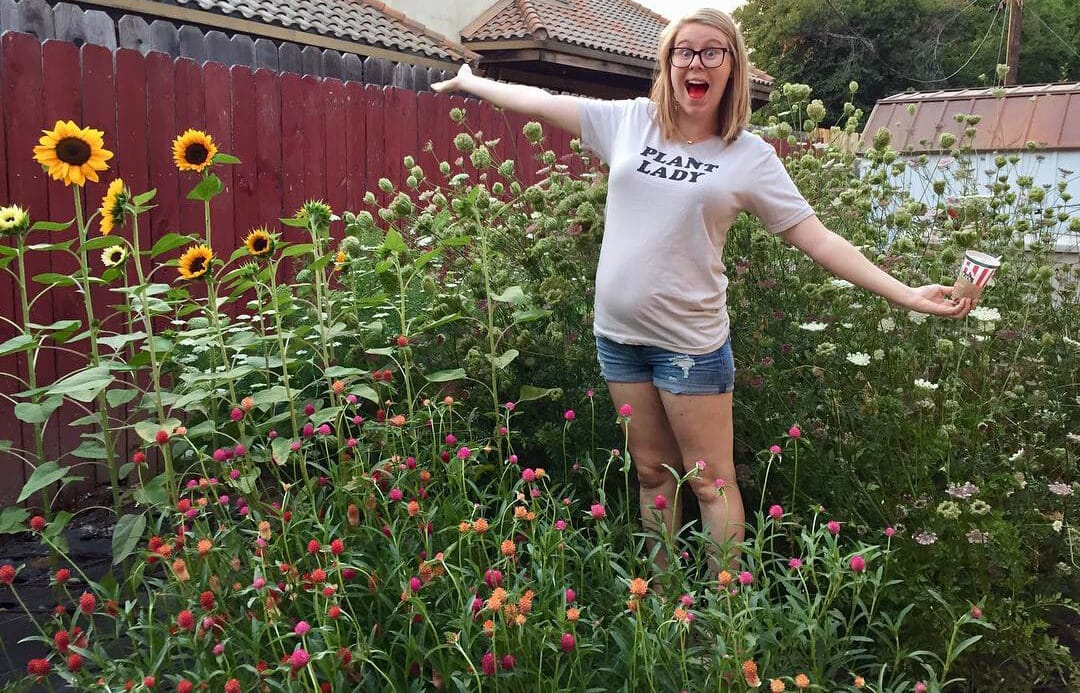 Amanda Kitaura of Bloom Sacramento standing in a field of flowers.