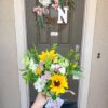 Local flowers from Bloom Sacramento being delivered to a front door.