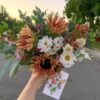 Arranged bouquet of local flowers from Bloom Sacramento being photographed at sunset.