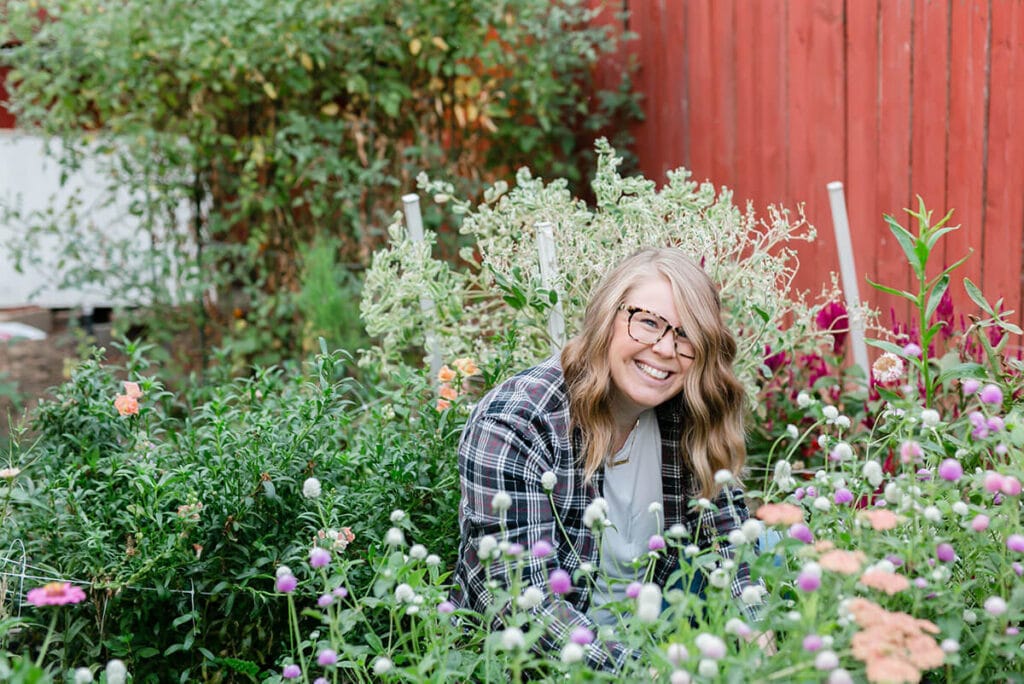 Amanda Kitaura sits in flower patch