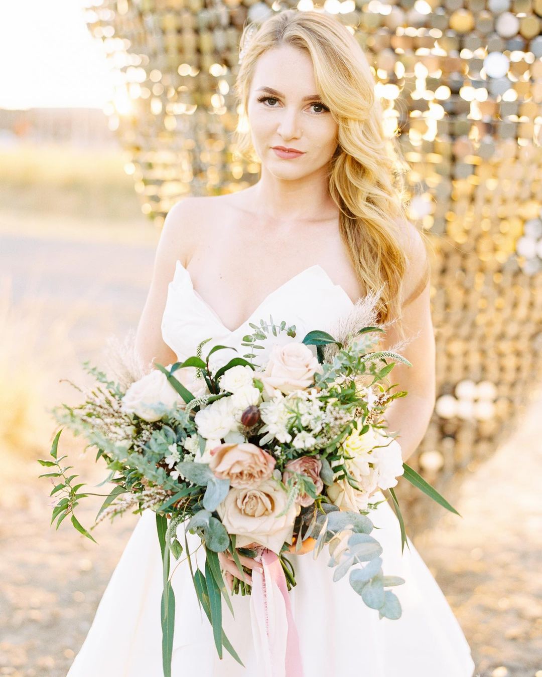 Bridge holds wedding bouquet designed by Bloom Sacramento