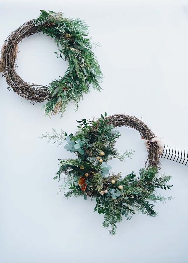 Two wreaths made by Bloom Sacramento sit against a white backdrop