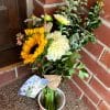 DIY flowers from Bloom Sacramento sitting in a reclaimed jar on someone's doorstep