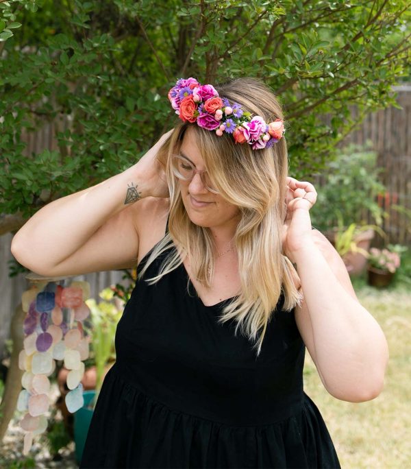 Woman wearing colorful flower crown made by Bloom Sacramento
