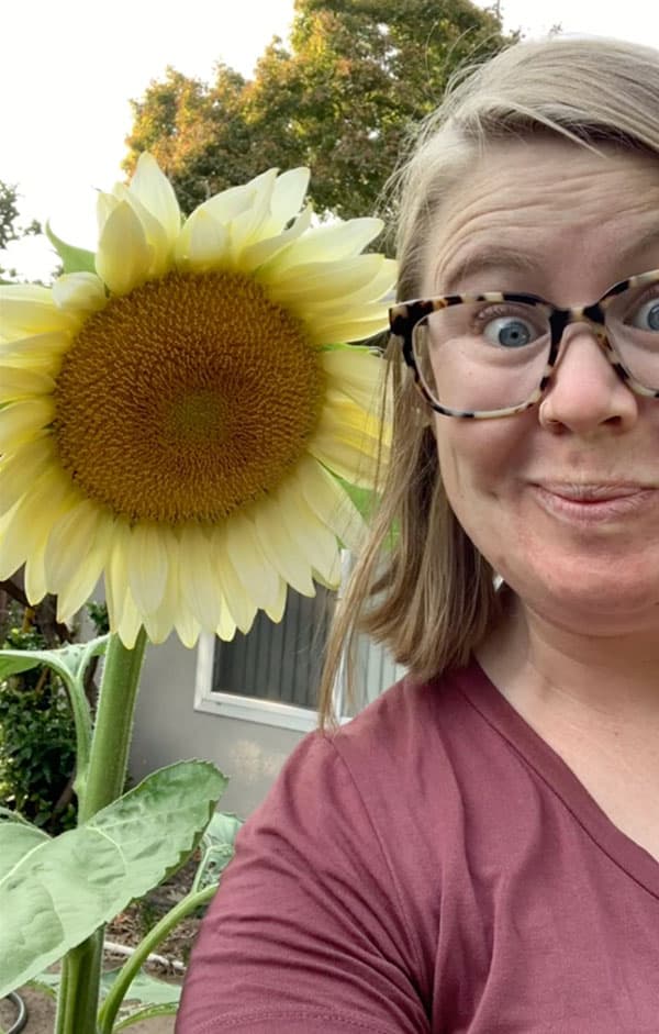 Amanda poses for selfie with large sunflower