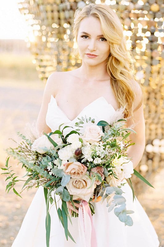 Bride holds bouquet made by Bloom Sacramento