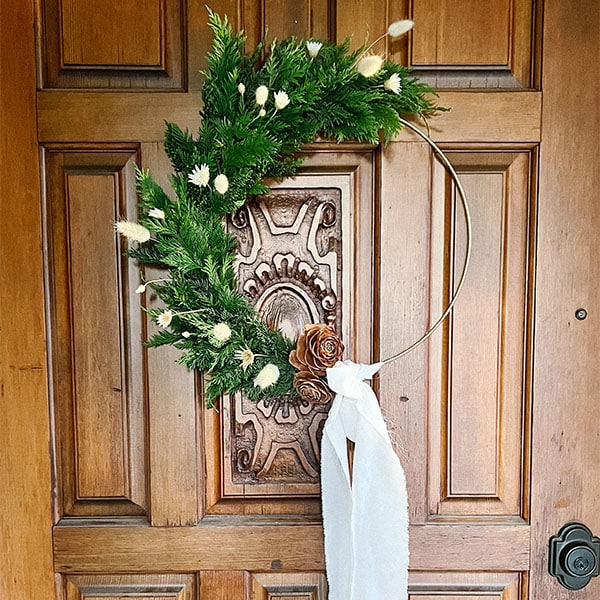 Wreath made by Bloom Sacramento with gold base hangs on door