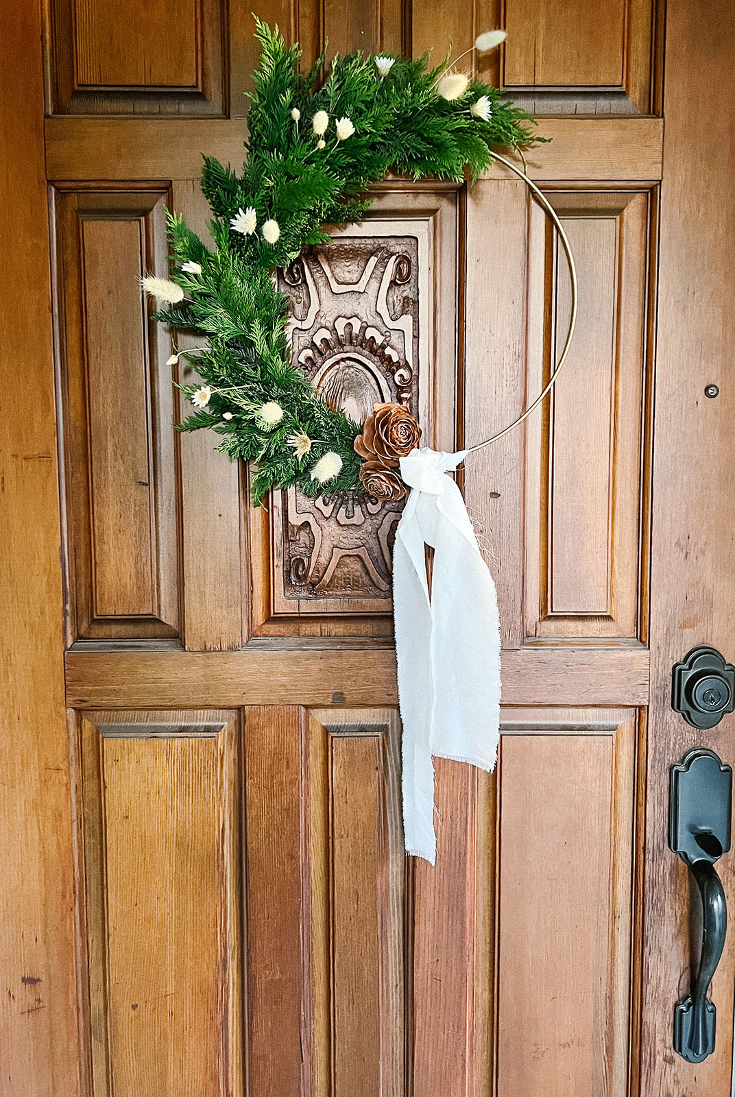 Wreath from Bloom Sacramento made with gold base hangs on door