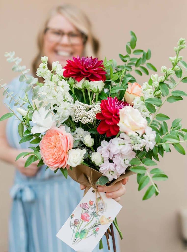Amanda Kitaura of Bloom Sacramento holds a bouquet of local flowers for delivery.