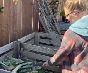 Amanda from Bloom Sacramento turning a backyard compost pile