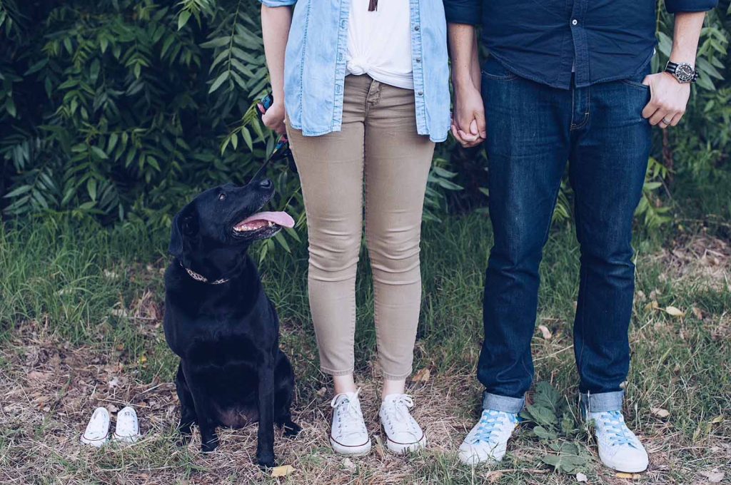 Photo showing dog, Amanda's legs, Cody's legs, and tiny pair of baby shoes.