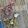 Two dried flower brooms made by Bloom Sacramento sit on a table