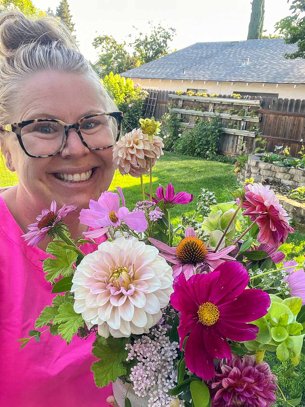 Amanda of Bloom holds a arrangement of flowers