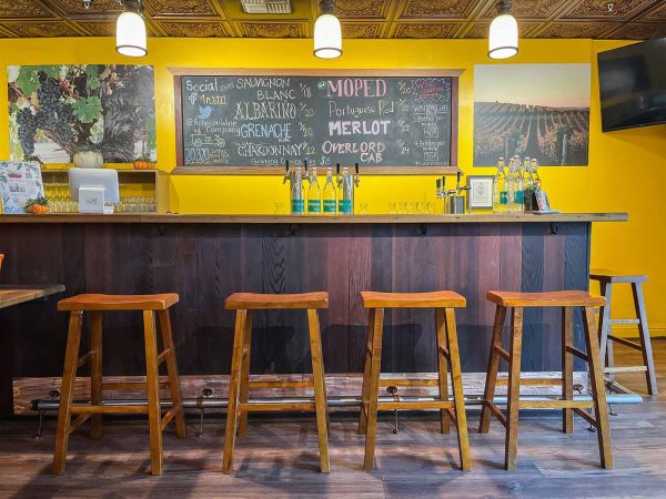 Photo shows stools in front of wine bar
