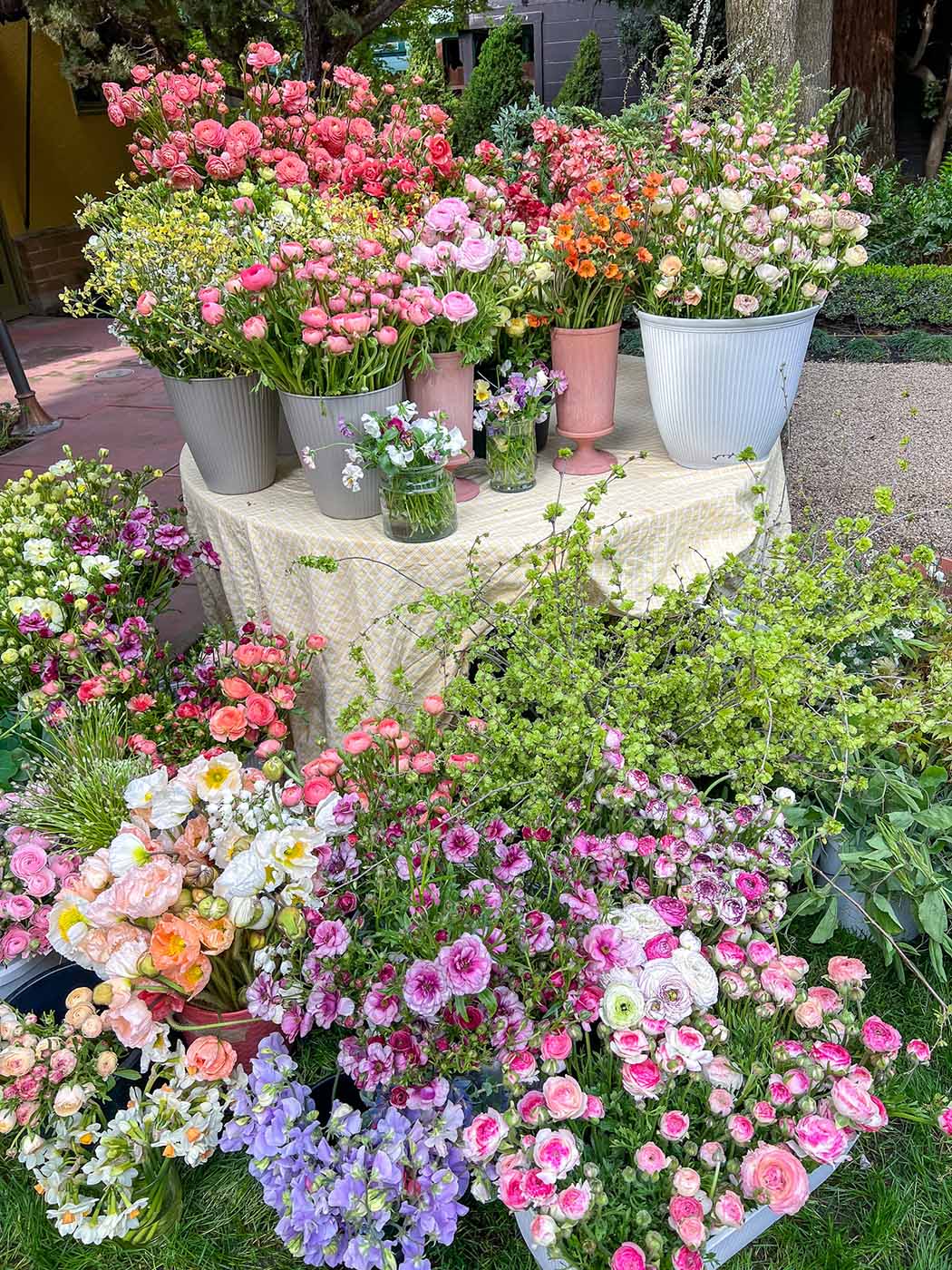 Multiple buckets of flowers on a display