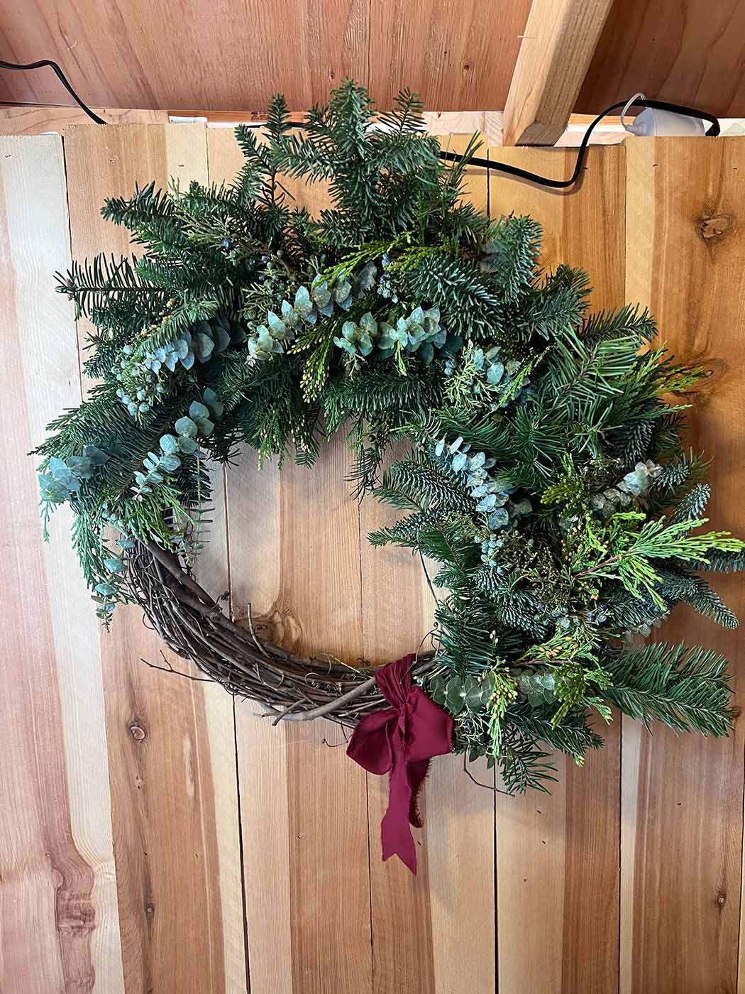 A wreath hanging on a wood wall
