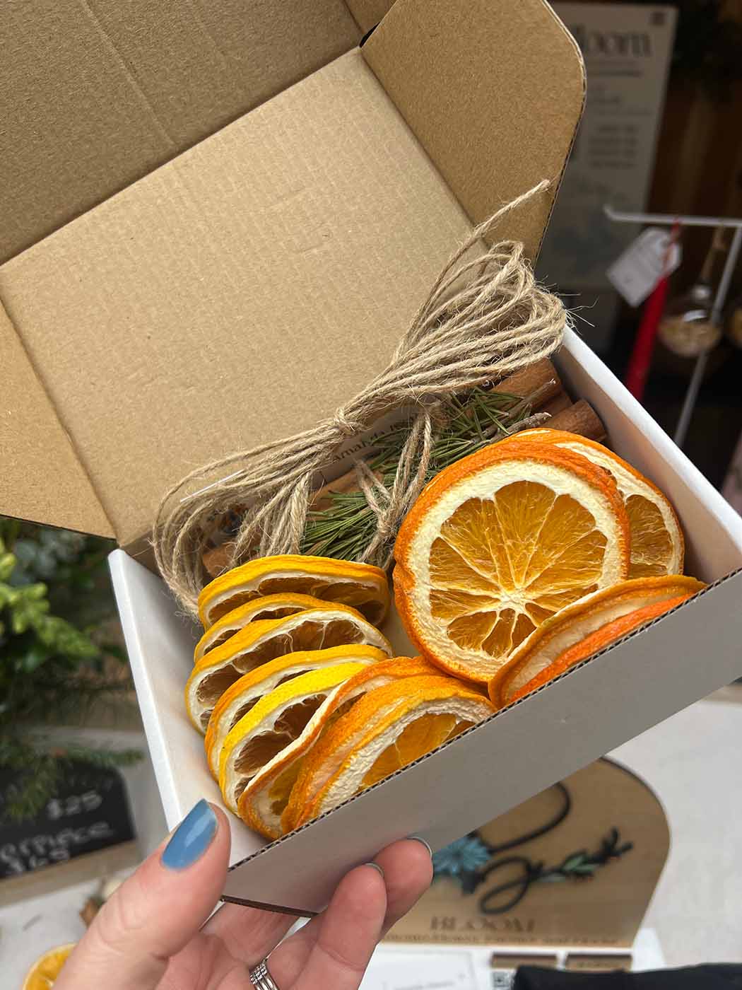 A box with dried oranges, twine and other items to create ornaments